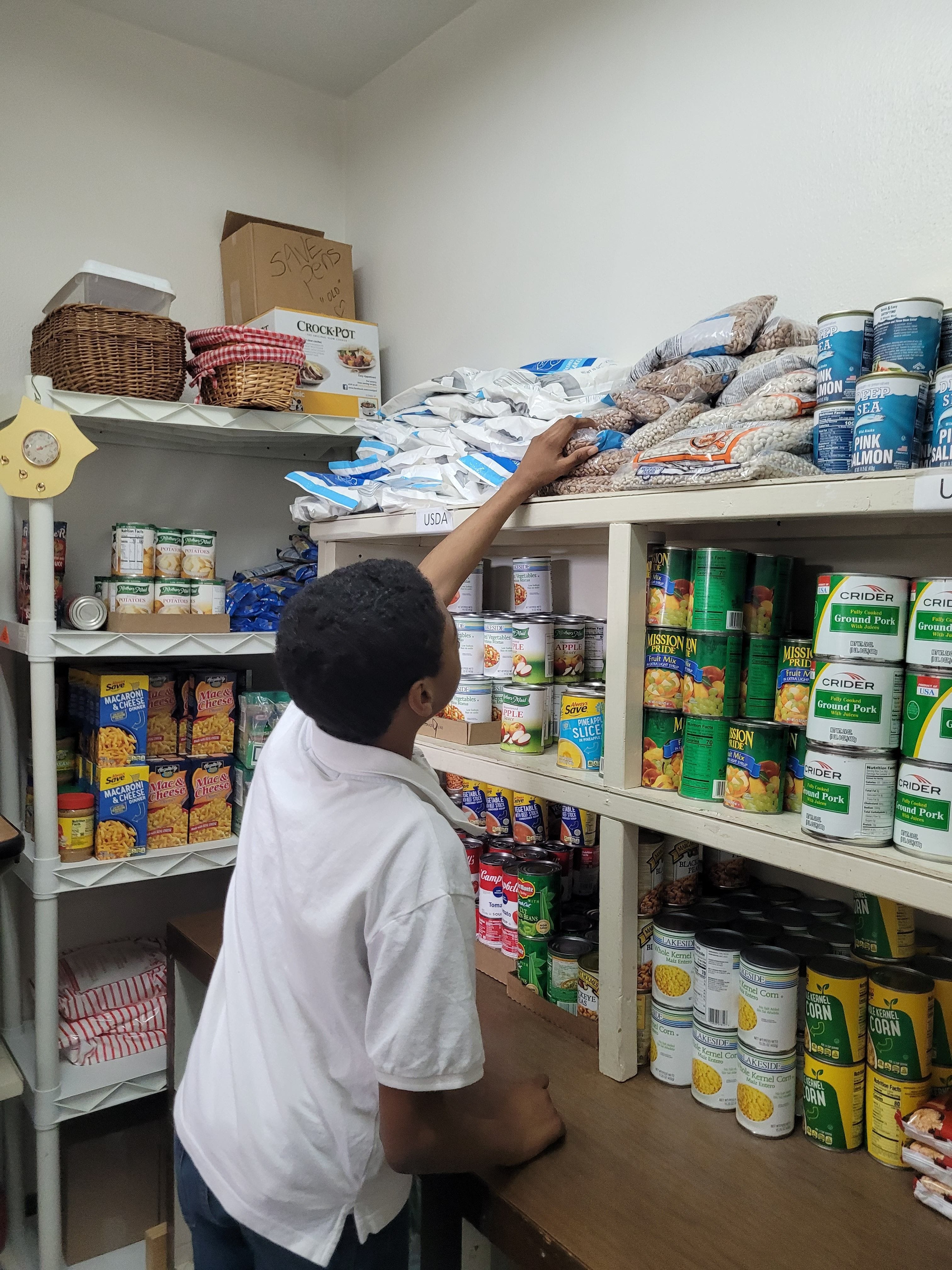 Student from El Dorado School District stocking the pantry while job shadowing.